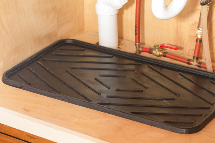 Boot tray under sink for plumbing drips