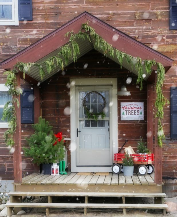 Rustic Log Home Christmas Porch, Fresh Cut Pines, Vintage Red Wagon, Grapevine Wreath, Pine Clippings, Boots, and Galvanized Buckets