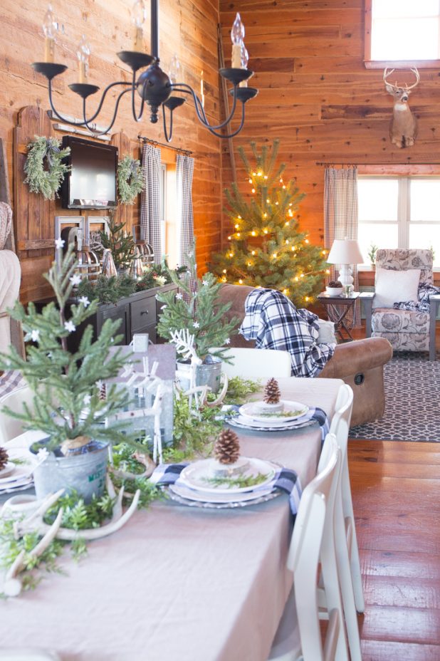Rustic Log Cabin Christmas Decor Using Black and White Buffalo Check Paired With Green. Wood Tones, Deer Antlers, Galvanized Metal, Natural Decor