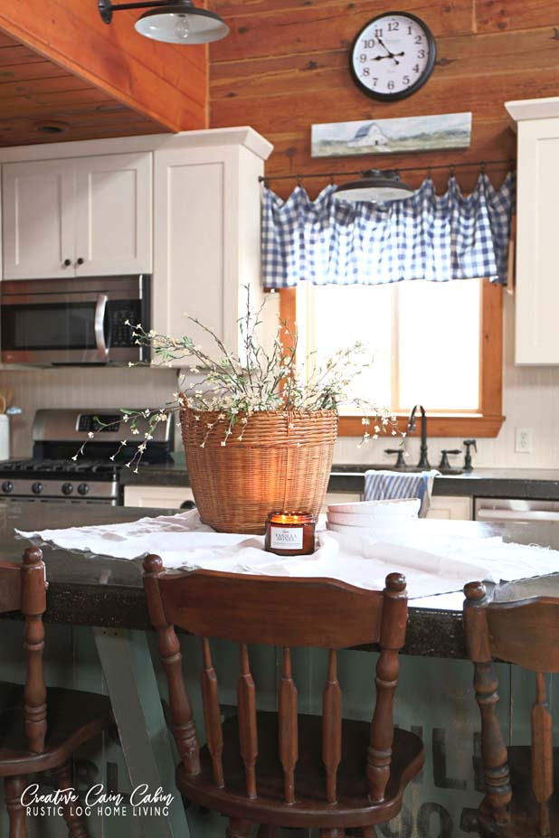 Spring Basket Centerpiece, Kitchen, Farmhouse Style, Log Home, White Cabinets, Gingham Curtain, Concrete Countertop